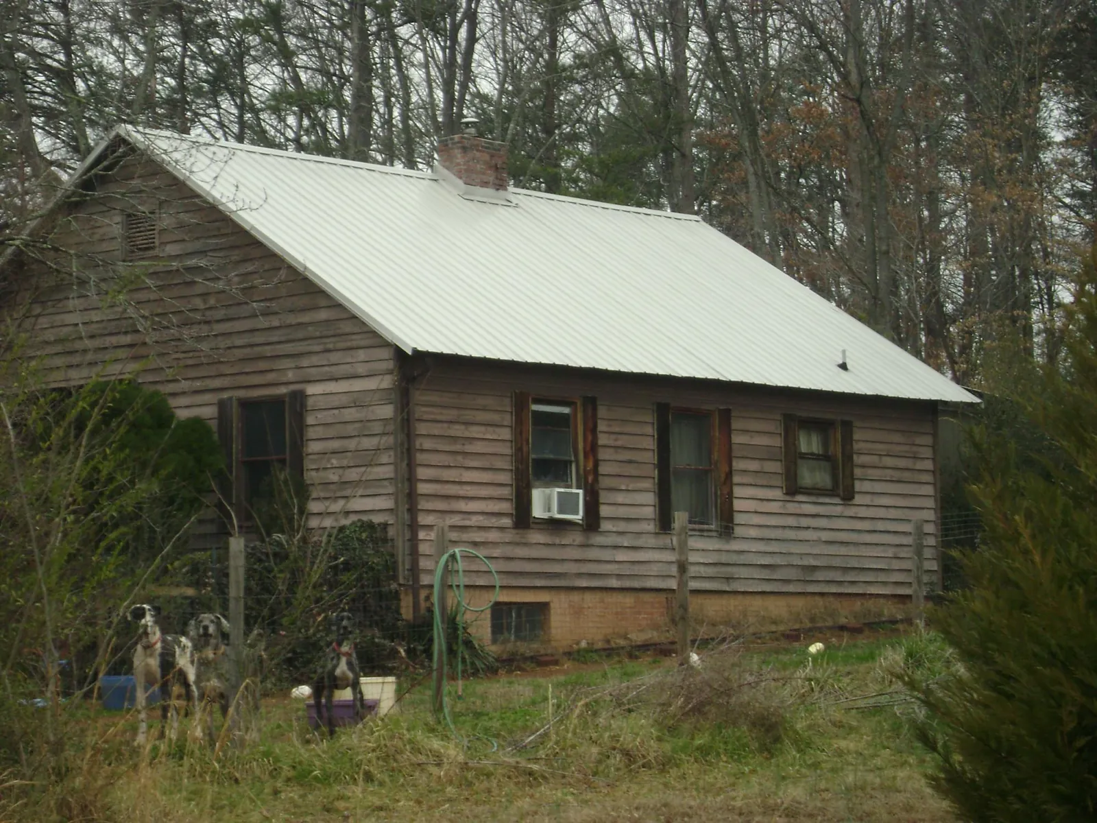 White metal roof on an old wood sided farmhouse, from a Asphalt Shingle Roof Repair job in Schulenburg